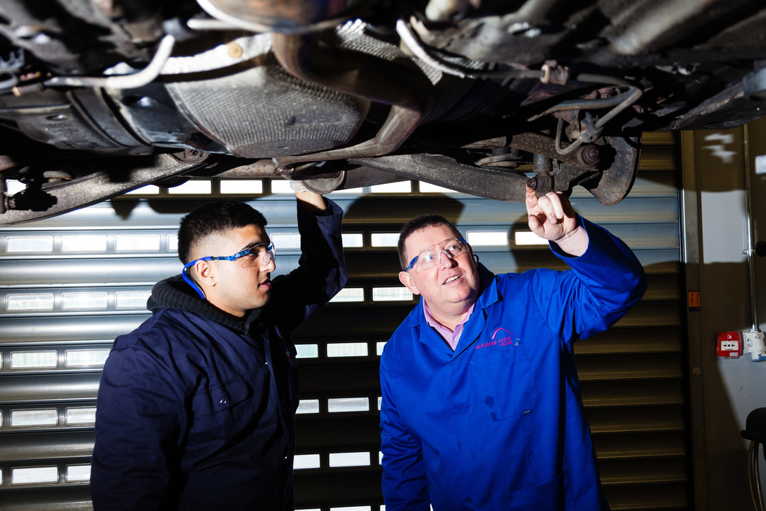 Automotive inspecting underneath car with lecturer 4 gallery