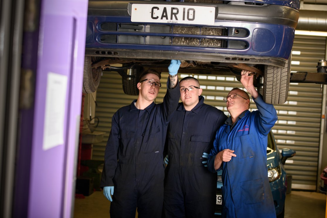 Automotive inspecting underneath car with lecturer %283%29 gallery