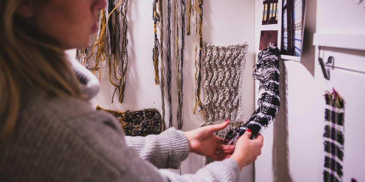 Fashion Textiles student looking through materials Glasgow Clyde College