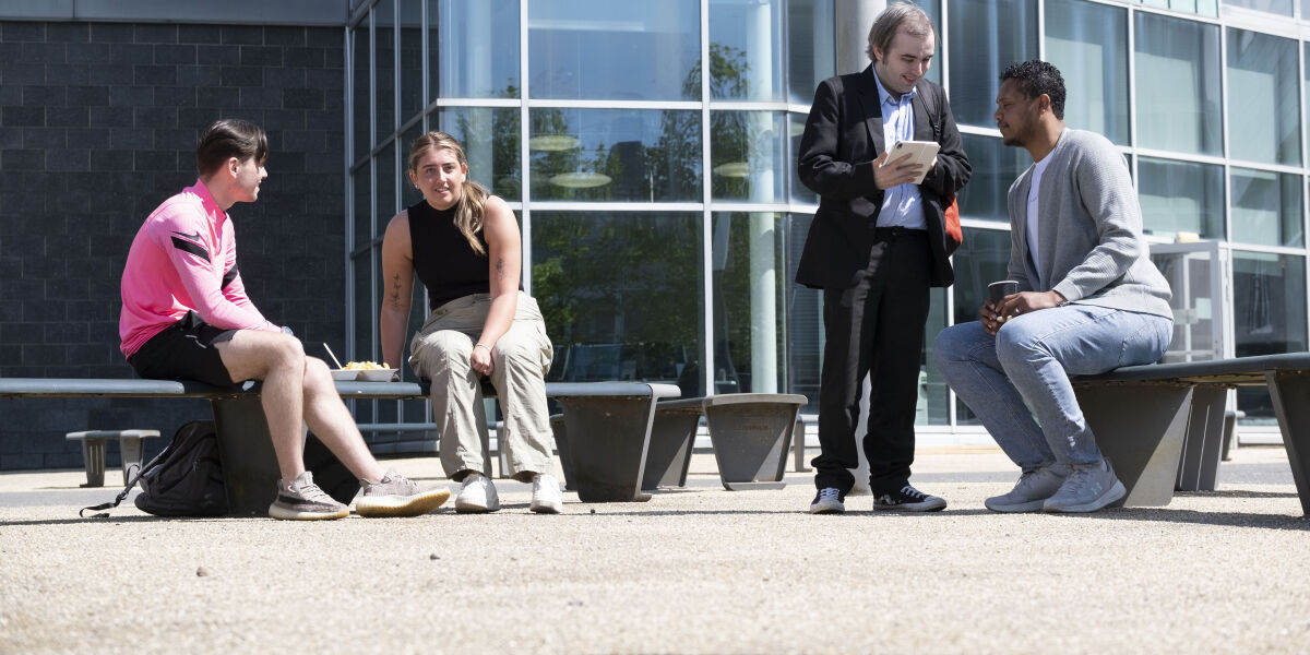 A group of students sitting outside at our Anniesland Campus. 