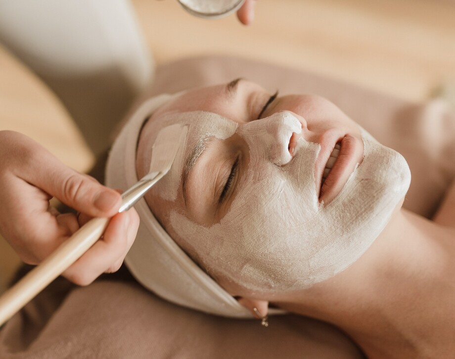A Beauty Therapy student administering a facial.