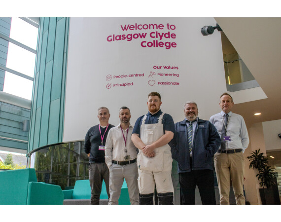 Image shows Persimmon Homes apprentice Ricky Booth with Ian McPherson from Persimmon Homes and Glasgow Clyde College Painting and Decorating teaching staff.