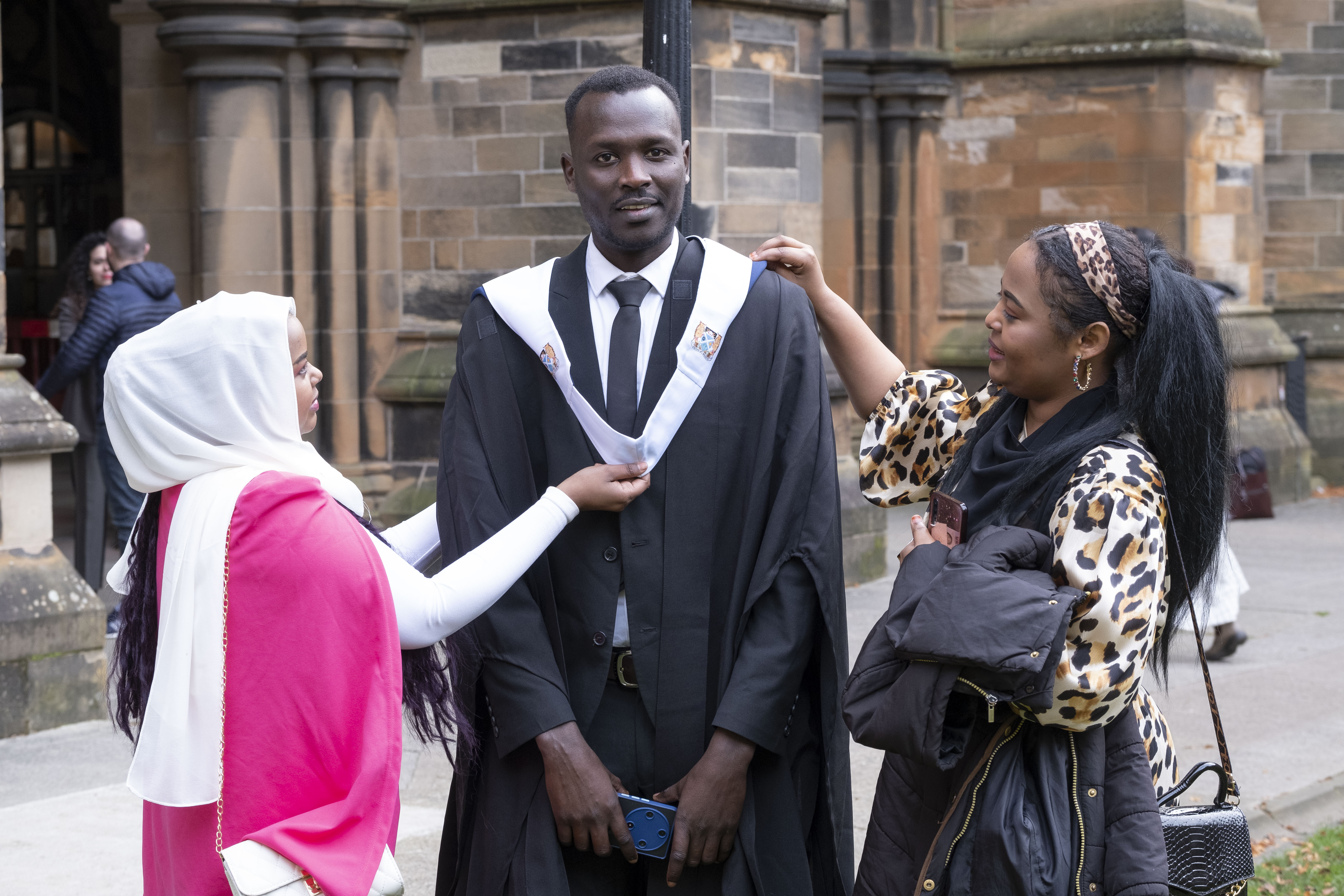 A male graduate with guests