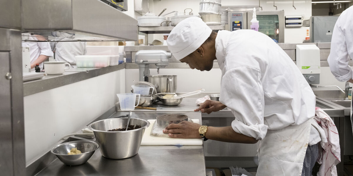 Male prepaing food in the kitchen